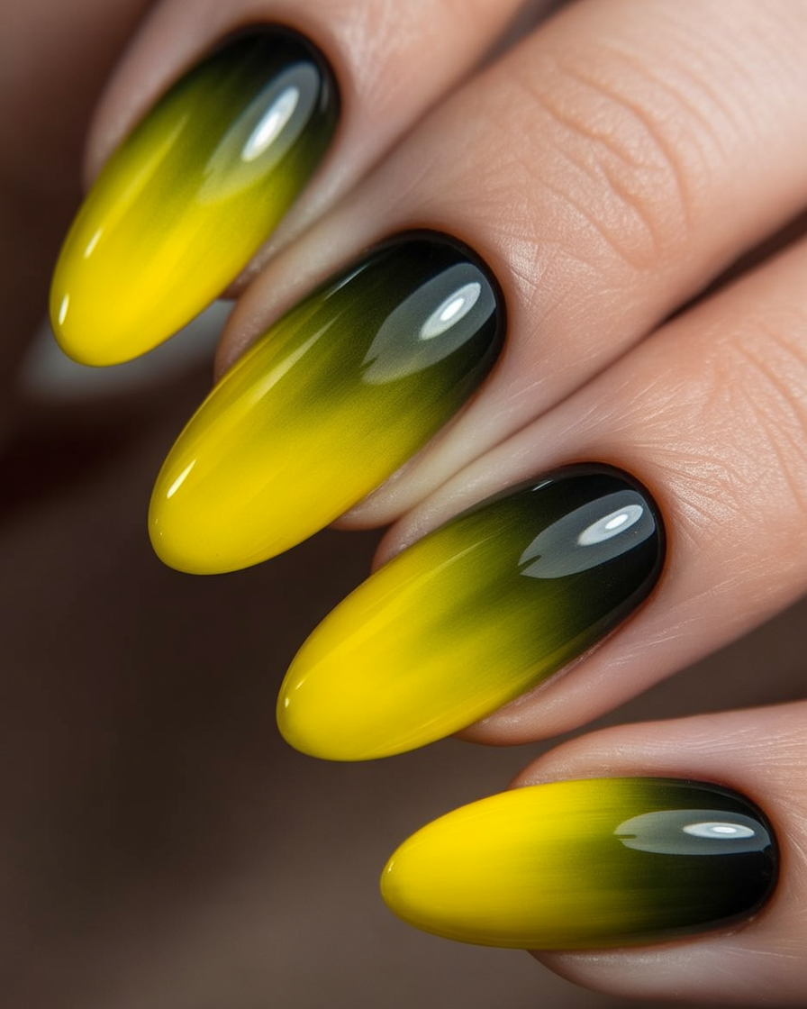 Almond nails with yellow-to-black gradient nail design.