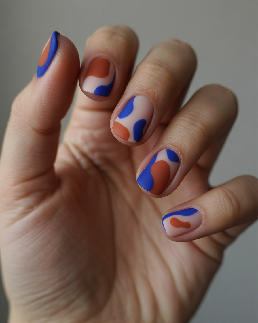 Abstract swirl nails in bold mixed colors and shapes.