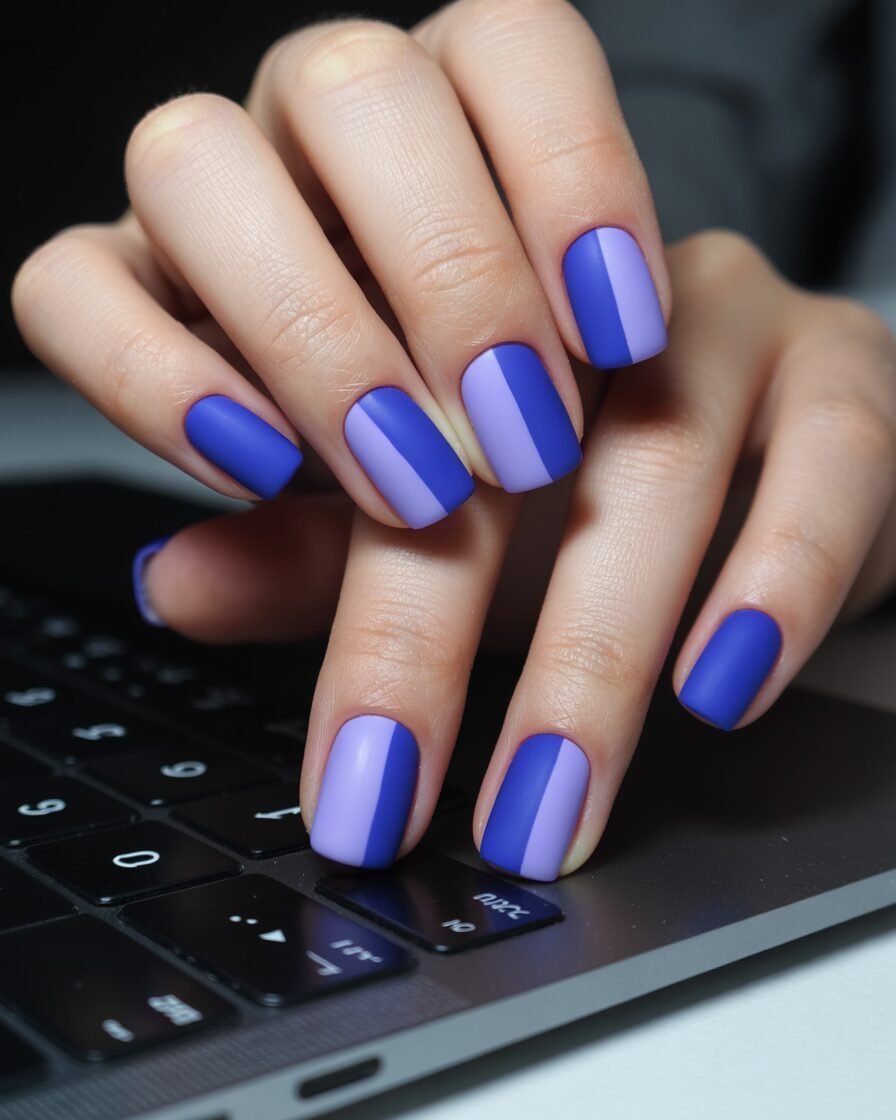 Matte color-blocked gel nails in cobalt blue and lavender