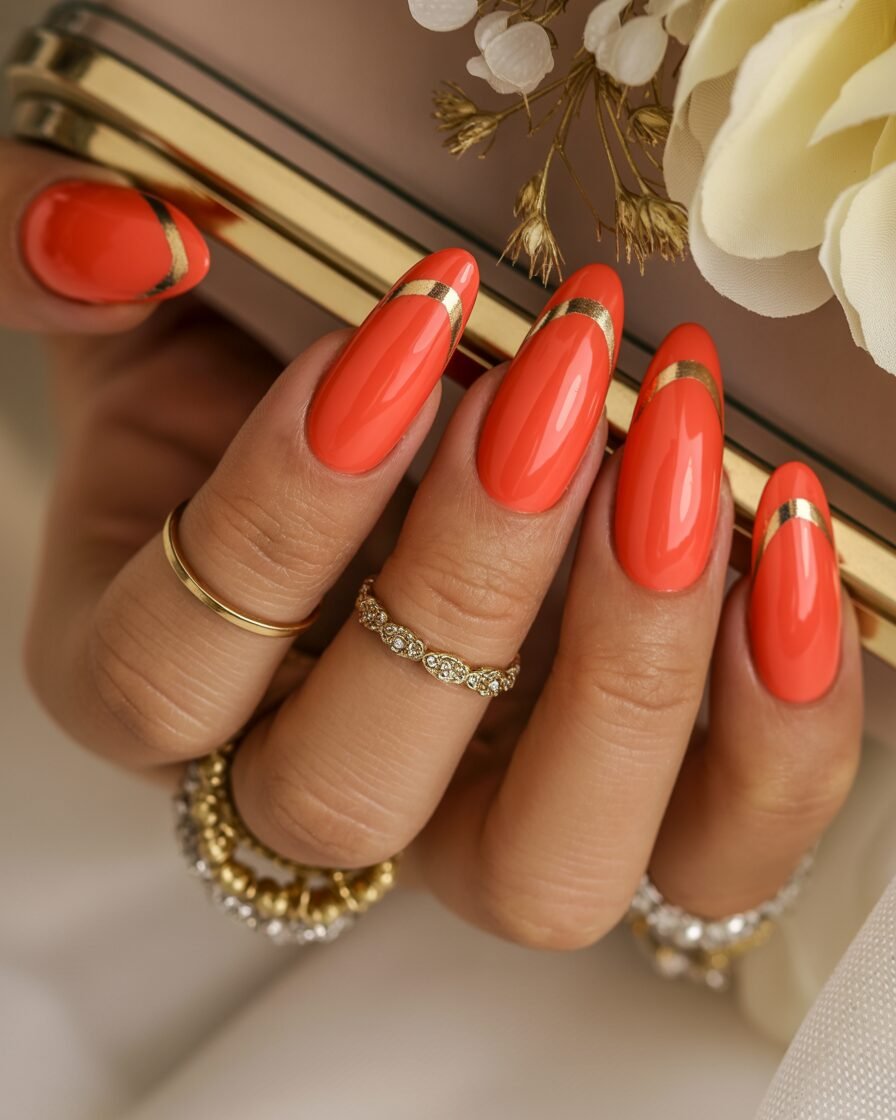 Coral nails with gold tips, adding a pop of color and luxury to your wedding day nails.