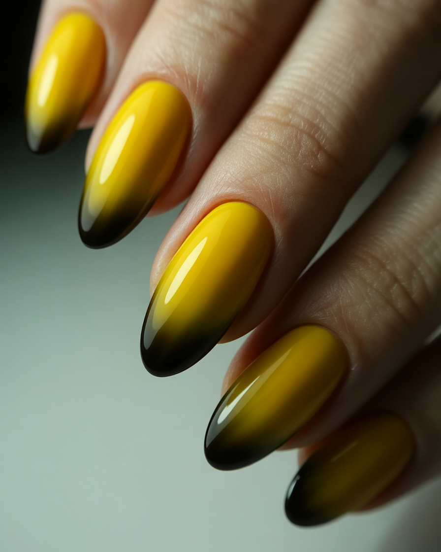 Yellow and black ombre almond nails.