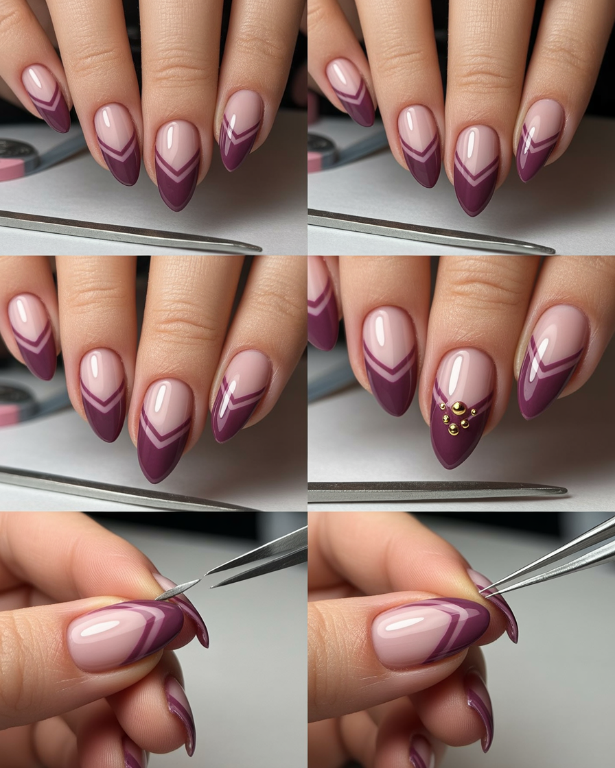 Burgundy and black double chevron nails with a gold stud at the cuticle.