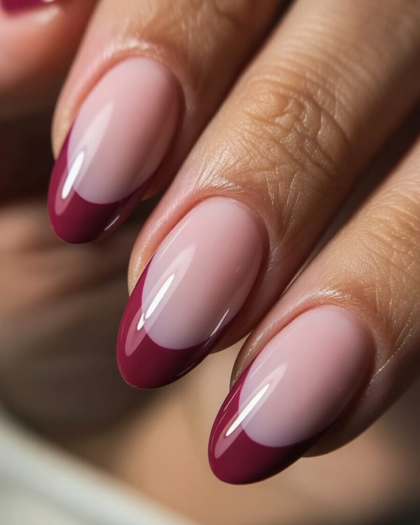 Burgundy-tipped nails with pastel pink base in a soft ombré fade.