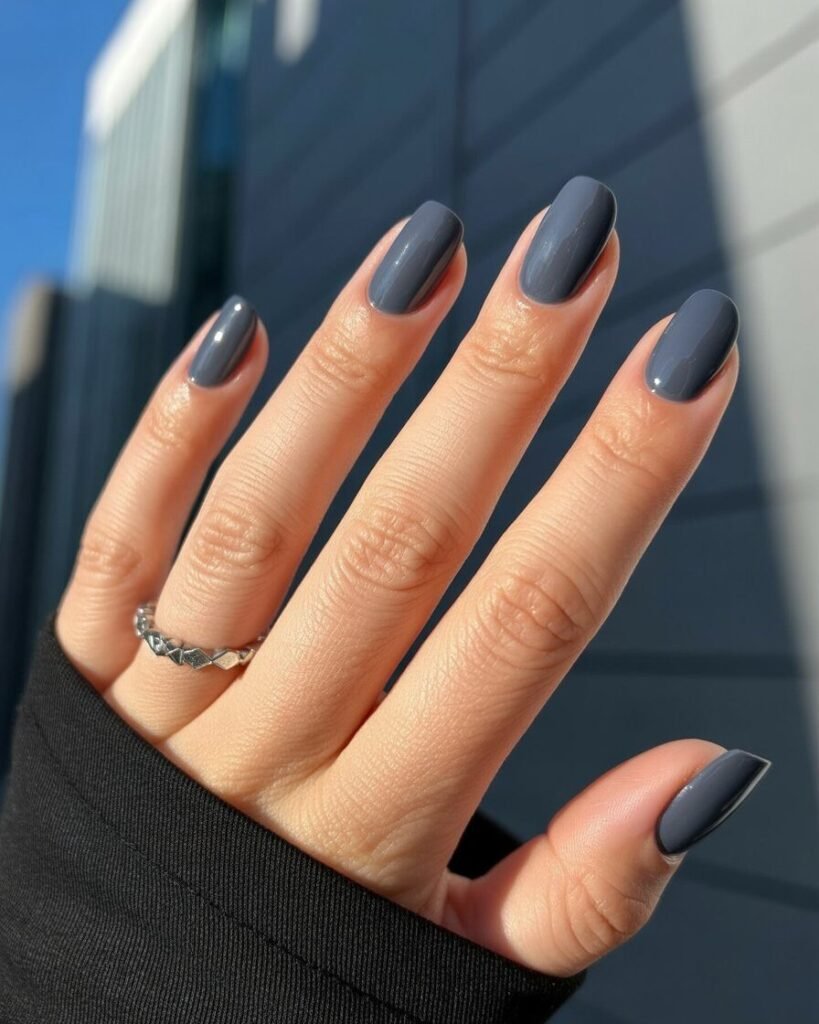Smoky graphite nails in deep gray with glossy finish, perfect for urban and professional looks.